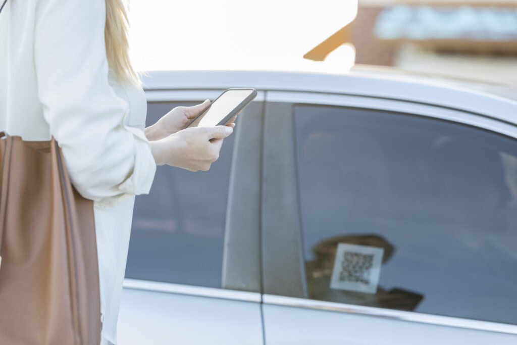 Person waiting for rideshare driver with phone out
